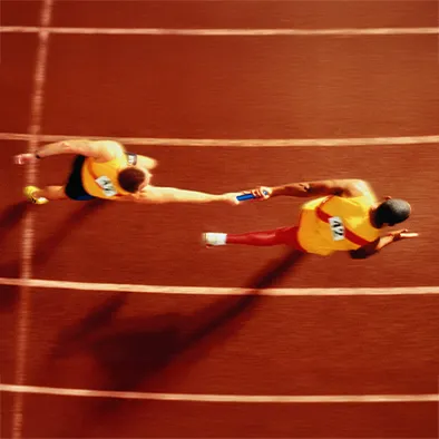 Elite runners passing a baton